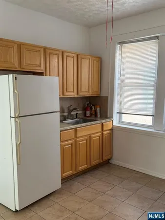 a kitchen with stainless steel appliances granite countertop a refrigerator sink and cabinets