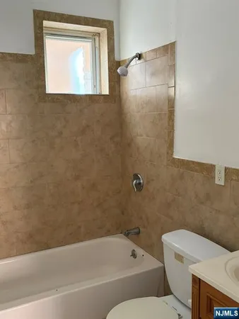 a bathroom with a toilet and a bathtub