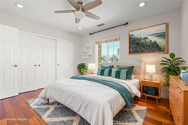 a view of walk in closet with wooden floor