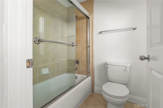 a view of empty room with wooden floor and fireplace