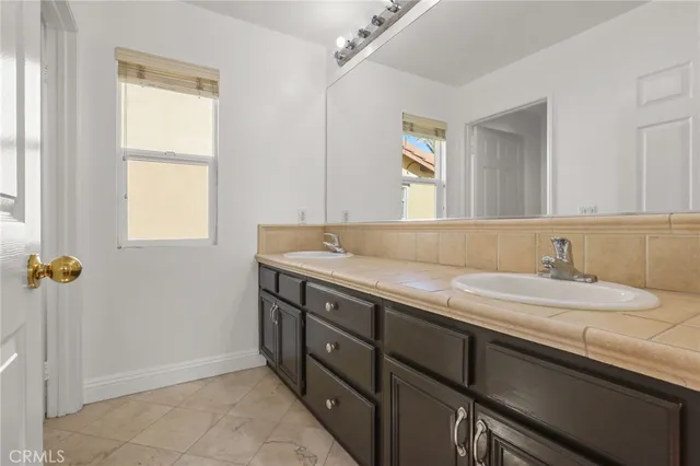 a view of a big room with wooden floor and windows