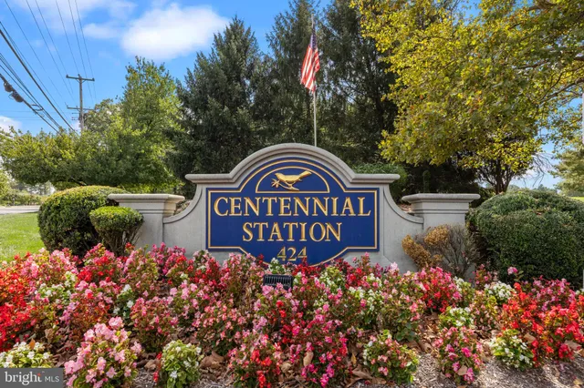 a sign that is in front of flowers