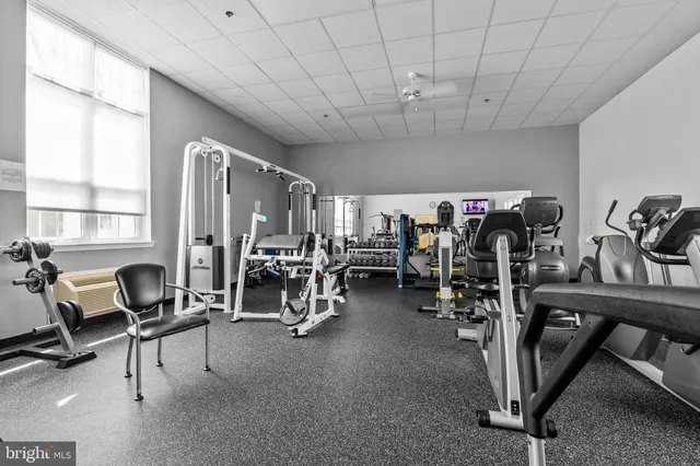 a living room with furniture a window and wooden floor
