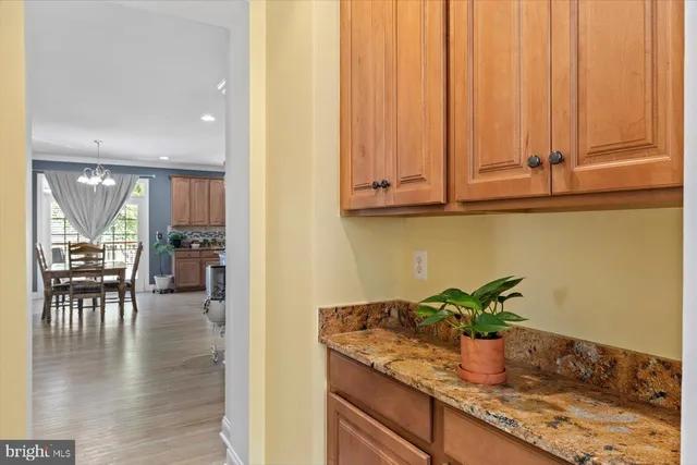 a hallway with dining area and wooden floor