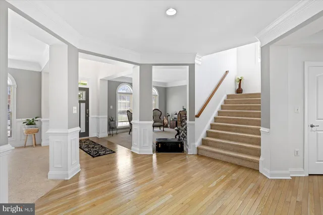 a view of a living room and entryway with wooden floor