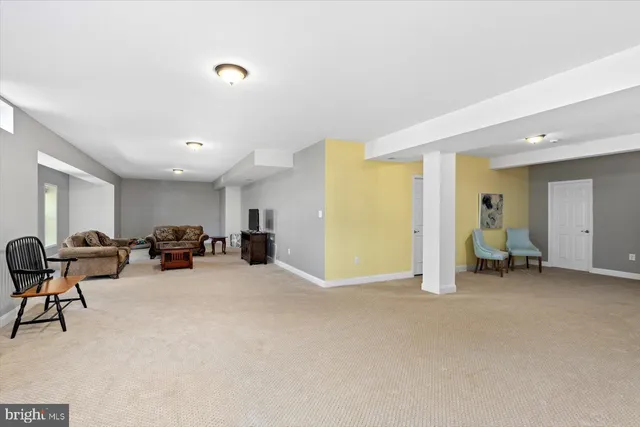 a view of a livingroom with furniture and a ceiling fan