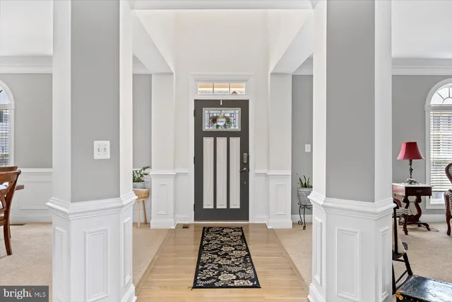 a view of a hallway with wooden floor and windows