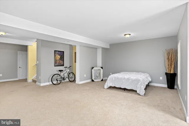 a bedroom with bed and a view of bedroom