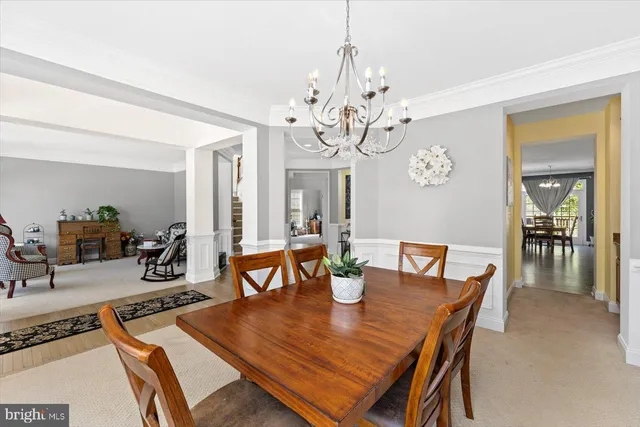 a view of a dining room with furniture wooden floor and chandelier