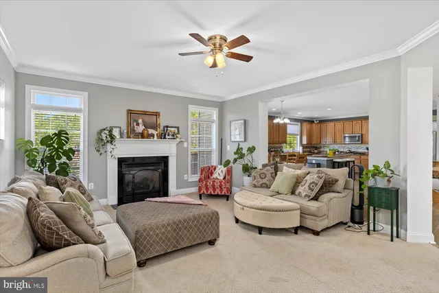 a living room with furniture fireplace and a large window