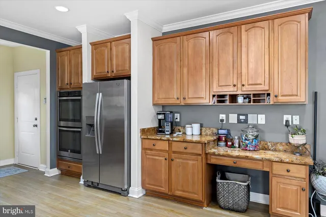 a kitchen with stainless steel appliances granite countertop a refrigerator sink and cabinets