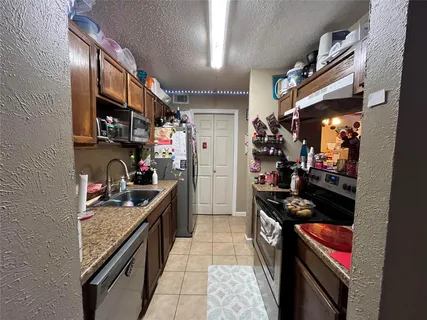 a kitchen with stainless steel appliances granite countertop a stove and a microwave