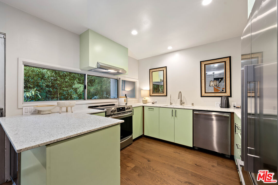 1116 Berkeley Drive Venice, CA 90292 - Photo 11 of 30 a kitchen with stainless steel appliances granite countertop a stove a sink and a refrigerator