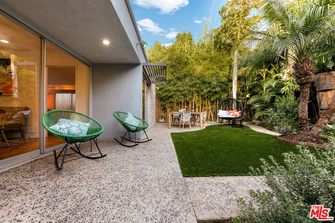 1116 Berkeley Drive Venice, CA 90292 - Photo 28 of 30 a view of a backyard with table and chairs potted plants and large tree