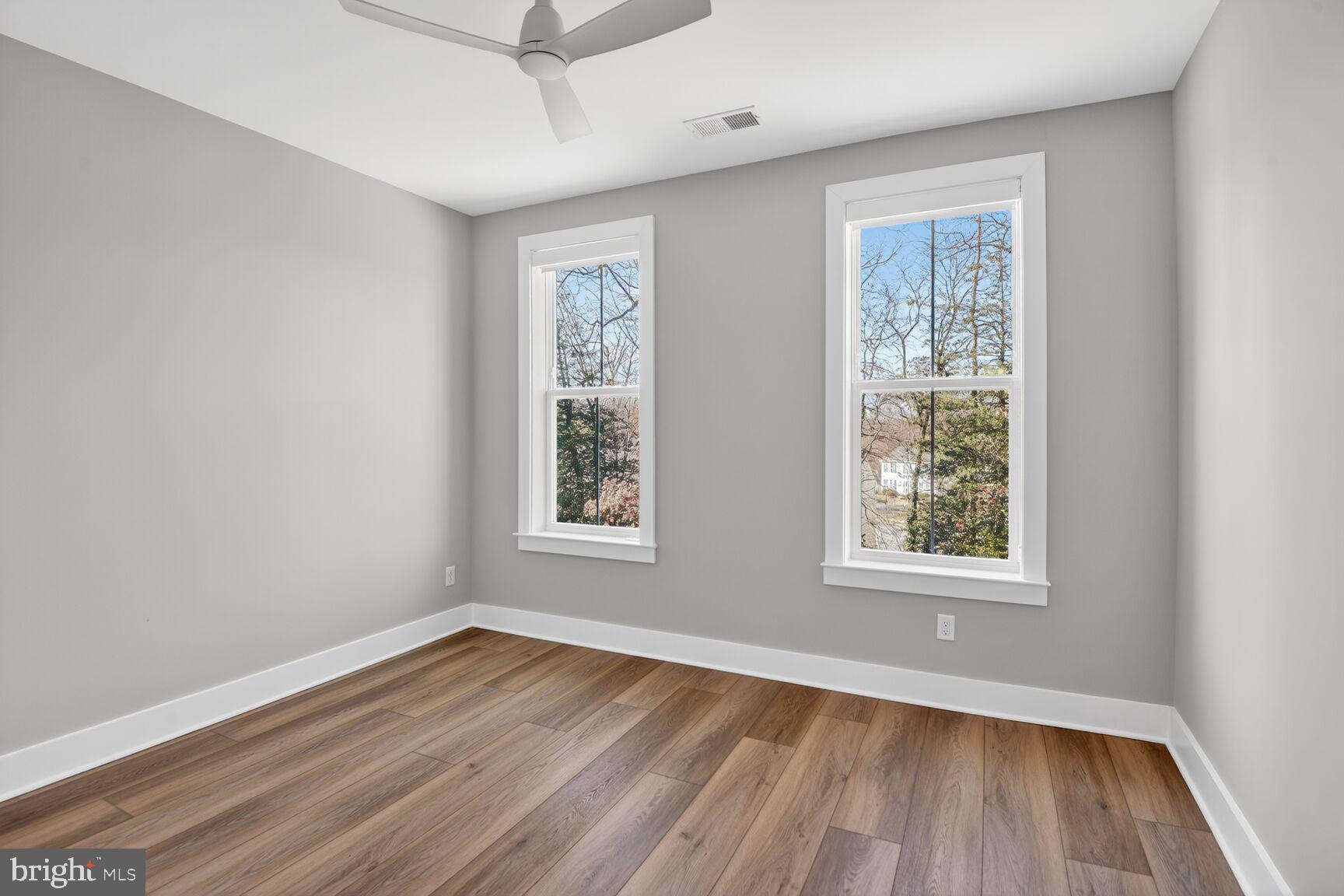 76 Old Mill Bottom Road North, Unit 301 Annapolis, MD 21409 - Photo 11 of 37 a view of an empty room with wooden floor and a window