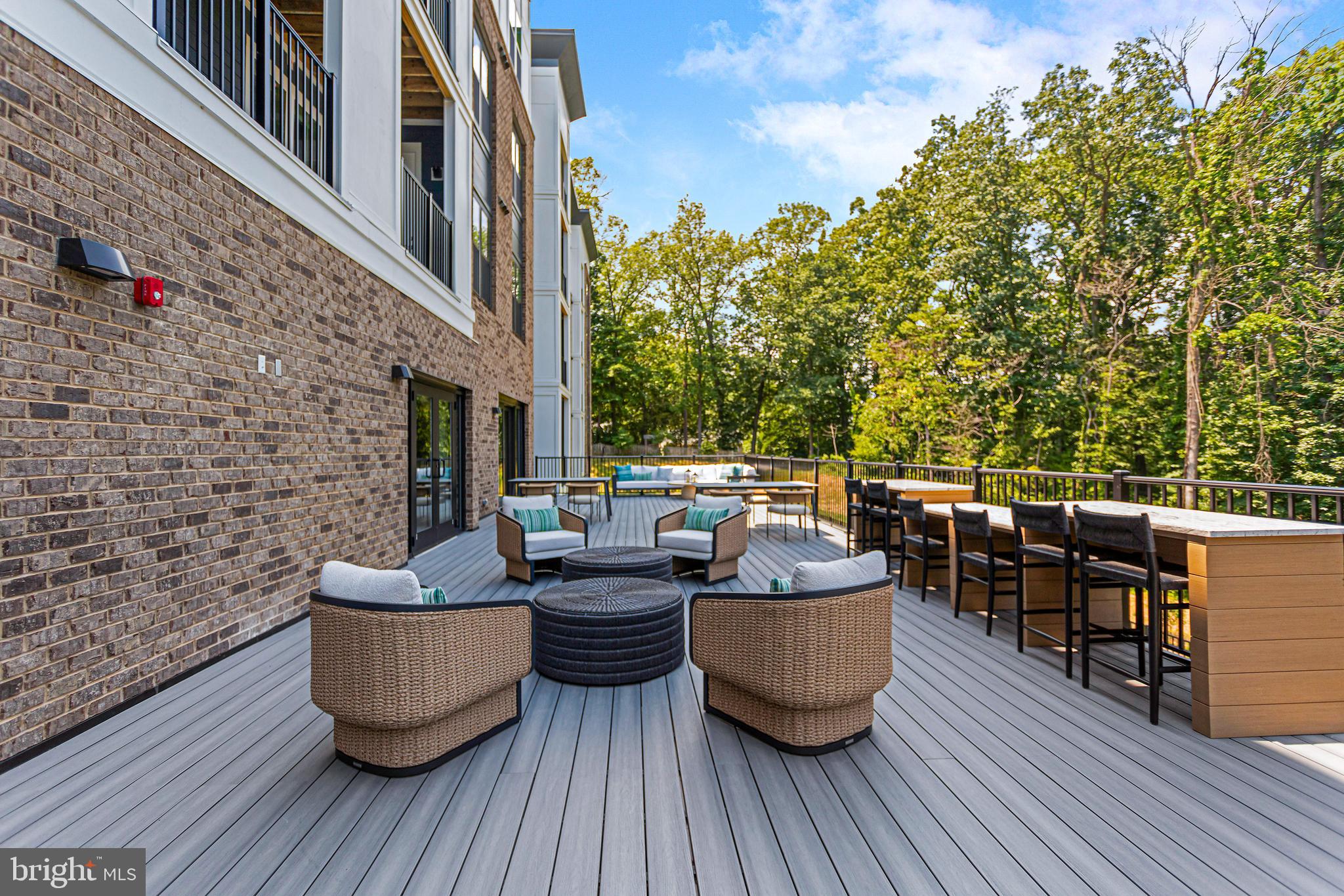 76 Old Mill Bottom Road North, Unit 301 Annapolis, MD 21409 - Photo 19 of 37 a view of a roof deck with table and chairs couches with wooden floor