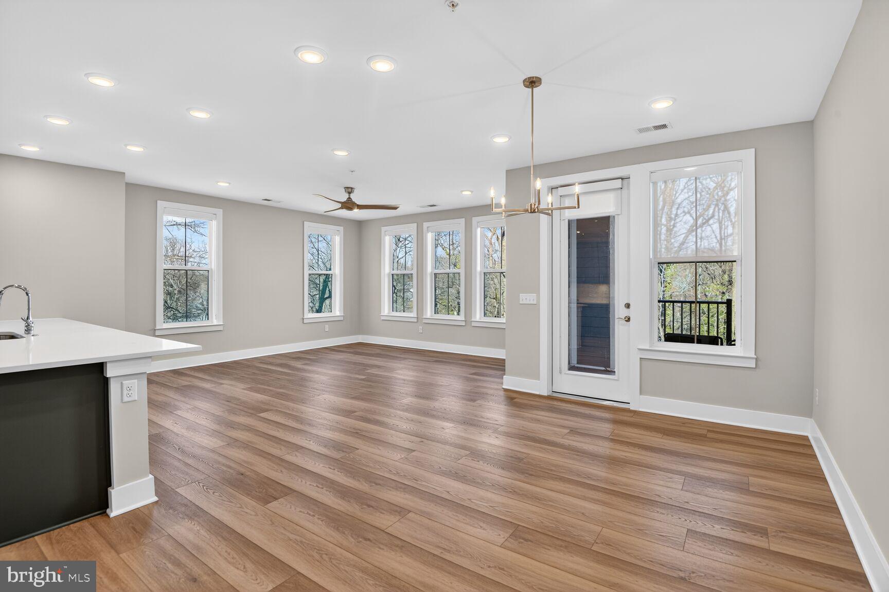 76 Old Mill Bottom Road North, Unit 301 Annapolis, MD 21409 - Photo 2 of 37 a view of an empty room with wooden floor and a window