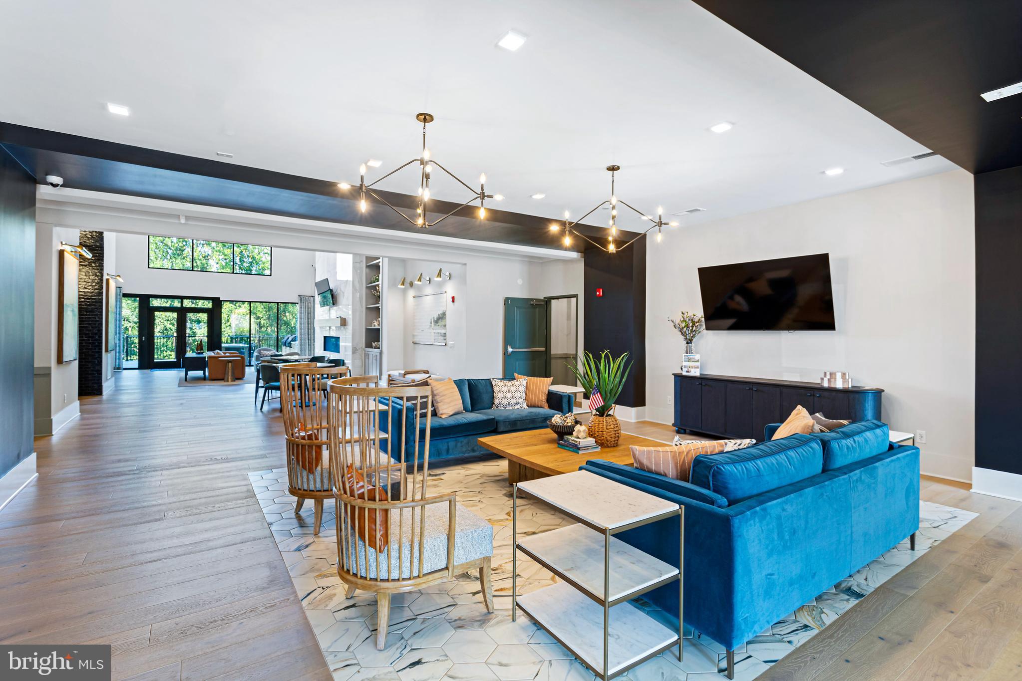 76 Old Mill Bottom Road North, Unit 301 Annapolis, MD 21409 - Photo 28 of 37 a living room with furniture a flat screen tv and a large window