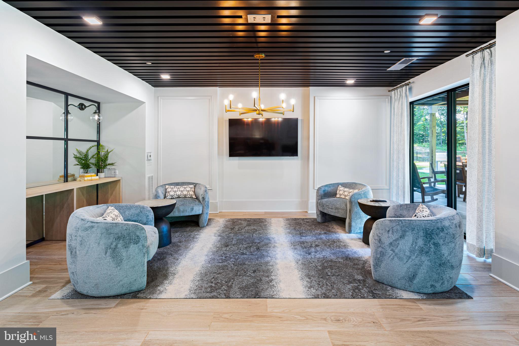 76 Old Mill Bottom Road North, Unit 301 Annapolis, MD 21409 - Photo 29 of 37 a living room with furniture and a flat screen tv