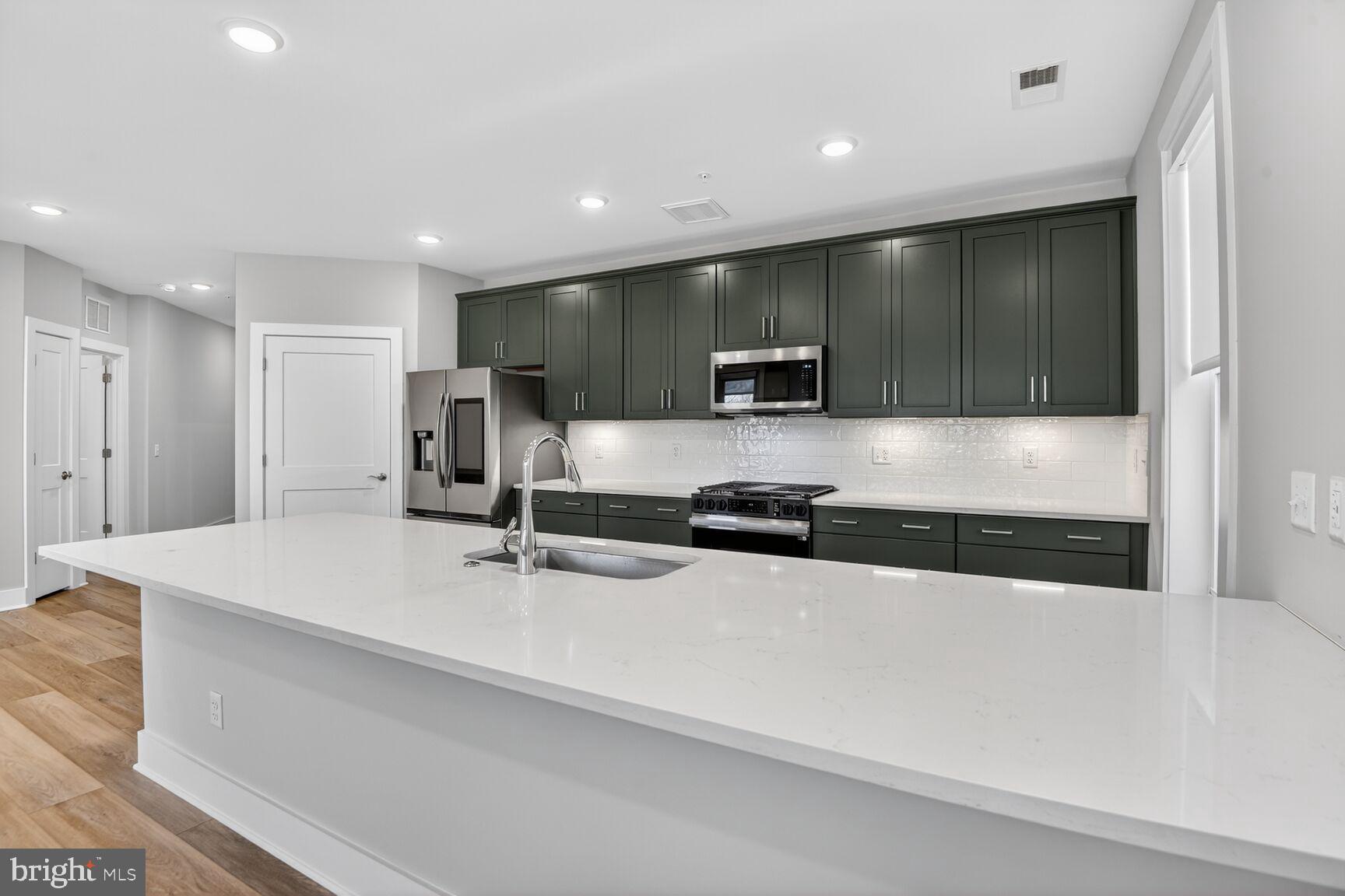76 Old Mill Bottom Road North, Unit 301 Annapolis, MD 21409 - Photo 4 of 37 a large kitchen with stainless steel appliances a large counter top