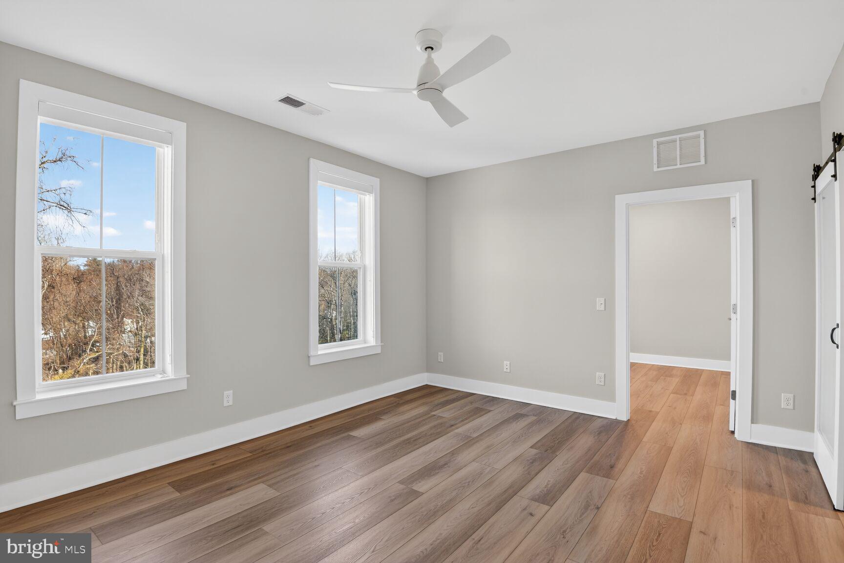 76 Old Mill Bottom Road North, Unit 301 Annapolis, MD 21409 - Photo 6 of 37 a view of an empty room with wooden floor and a window