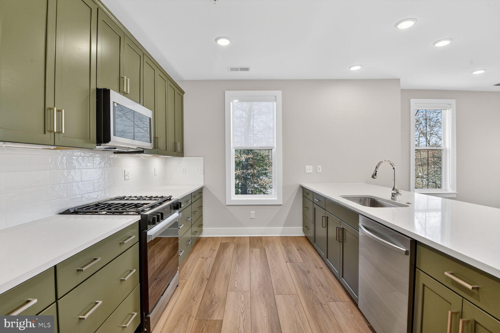 76 Old Mill Bottom Road North, Unit 301 Annapolis, MD 21409 - Photo 7 of 37 a kitchen with granite countertop stainless steel appliances a sink stove top oven and cabinets