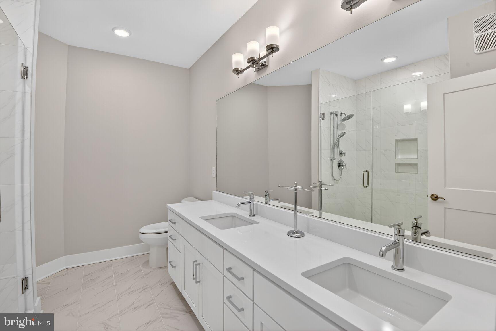 76 Old Mill Bottom Road North, Unit 301 Annapolis, MD 21409 - Photo 10 of 37 a bathroom with a double vanity sink mirror and toilet