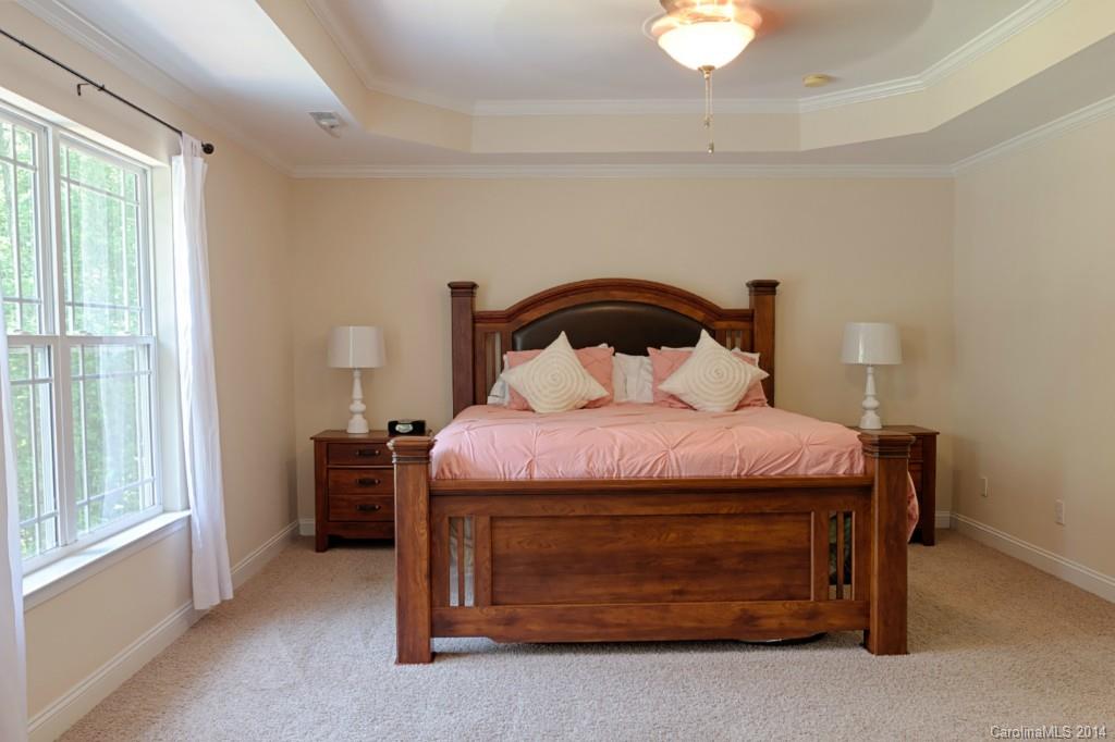 6312 Hastings Road Waxhaw, NC 28173 - Photo 11 of 24 a bedroom with a bed and a chandelier