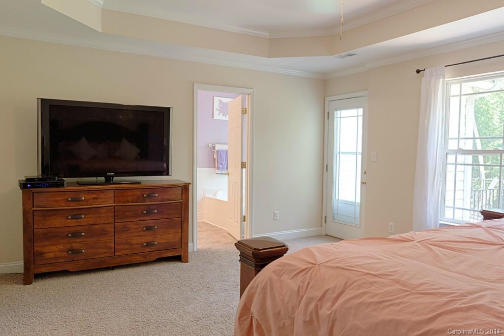 6312 Hastings Road Waxhaw, NC 28173 - Photo 12 of 24 a bedroom with a bed and flat screen tv