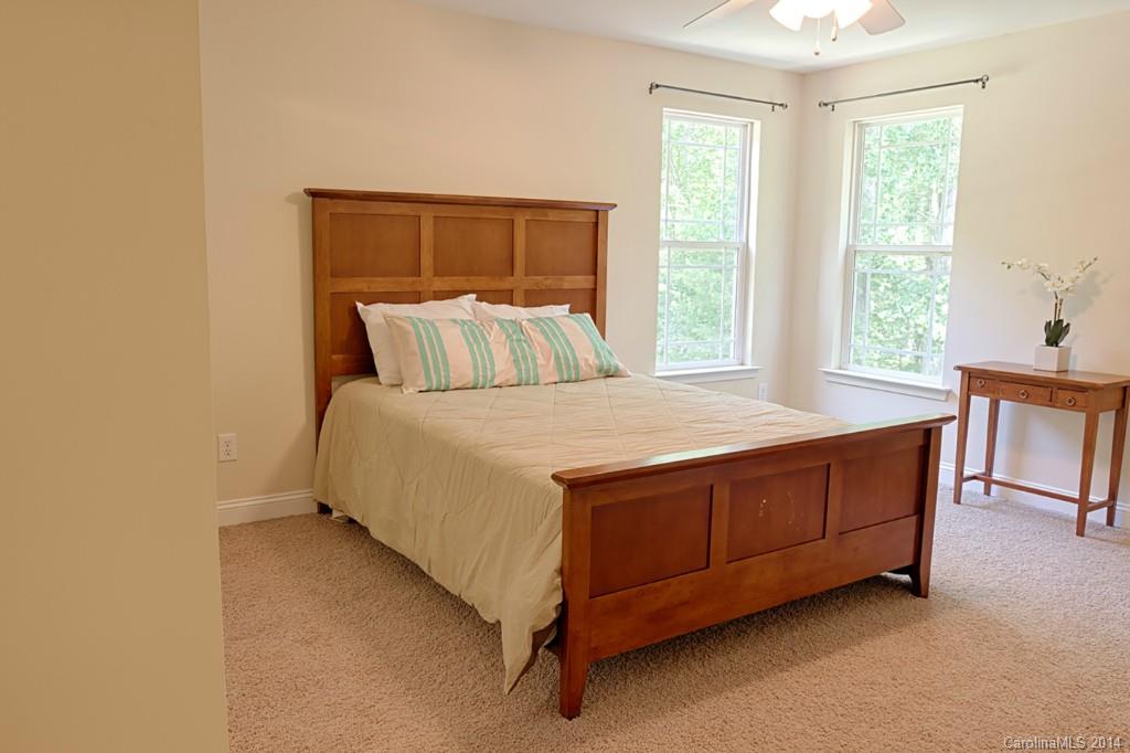 6312 Hastings Road Waxhaw, NC 28173 - Photo 16 of 24 a bed sitting in a bedroom next to a window
