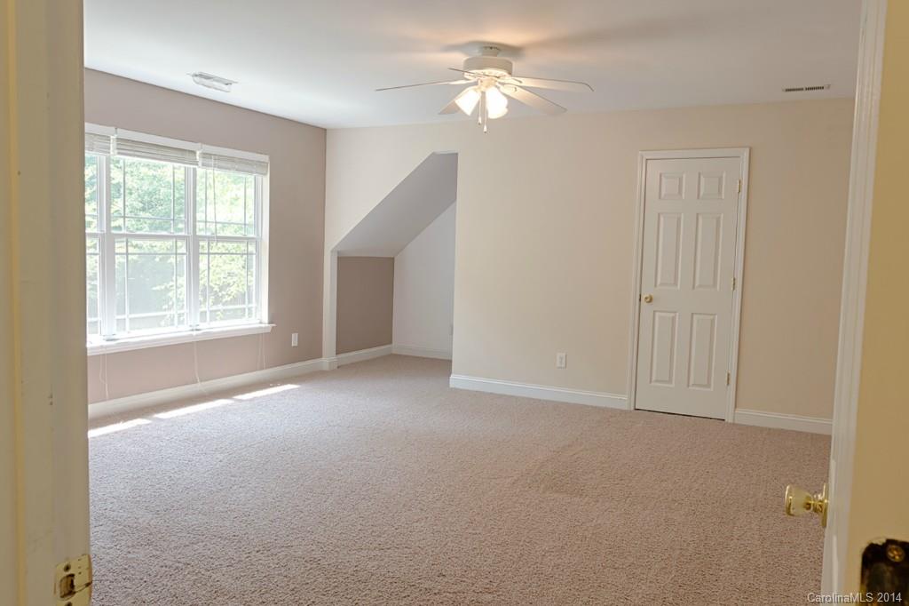 6312 Hastings Road Waxhaw, NC 28173 - Photo 18 of 24 an empty room with windows and fan