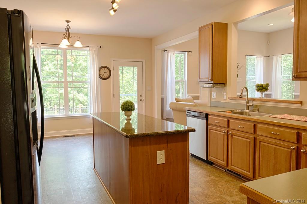 6312 Hastings Road Waxhaw, NC 28173 - Photo 5 of 24 a bathroom with a double vanity sink a mirror and a bathtub