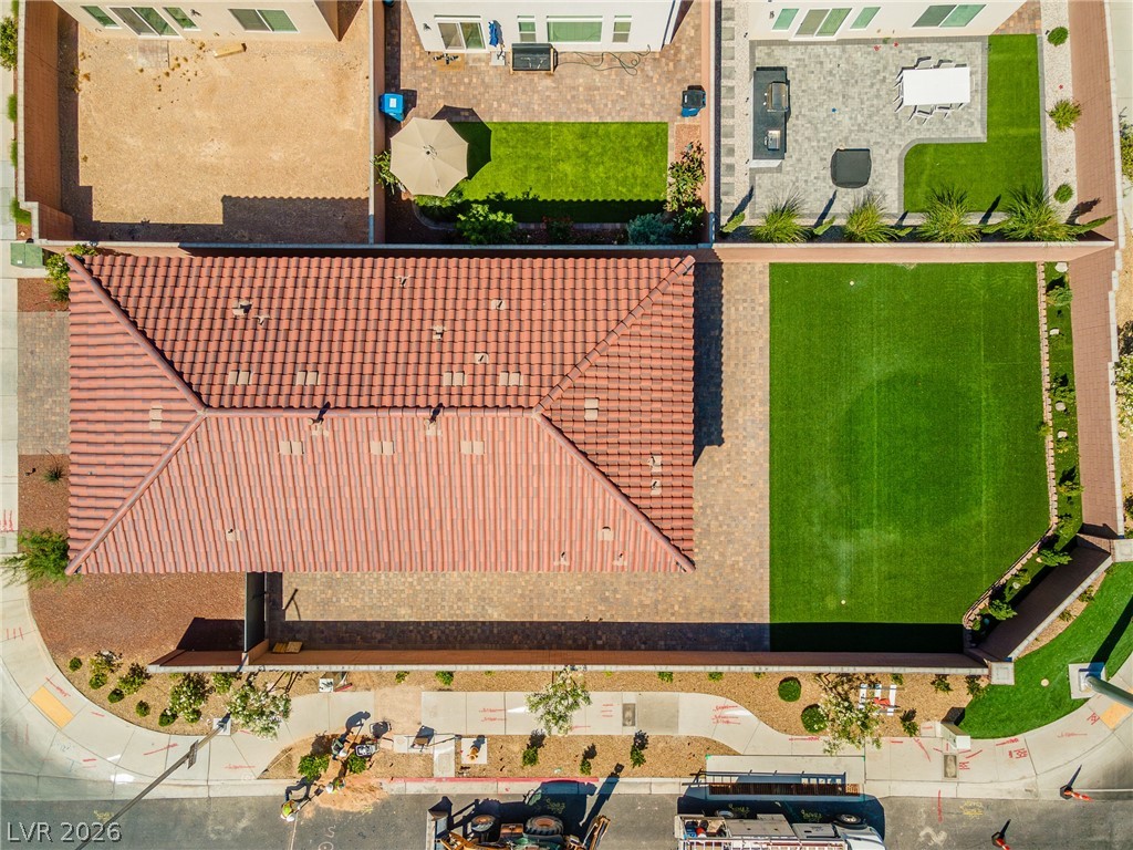 5510 Ripple Ridge Avenue Las Vegas, NV 89139 - Photo 4 of 45 This aerial view showcases a vibrant green yard, a tiled patio, and a durable tile roof.
