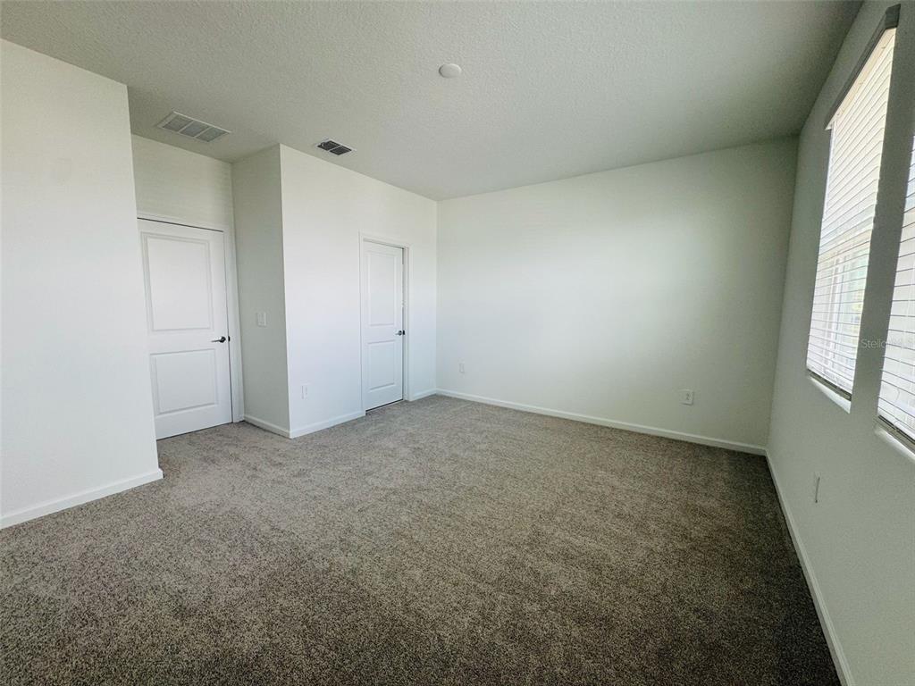 2473 Spring Tune Alley Kissimmee, FL 34744 - Photo 19 of 27 an empty room with windows