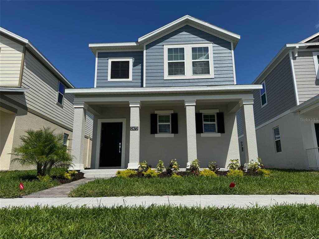 2473 Spring Tune Alley Kissimmee, FL 34744 - Photo 2 of 27 a front view of house with a yard