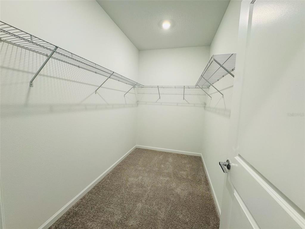 2473 Spring Tune Alley Kissimmee, FL 34744 - Photo 21 of 27 a view of a room with racks on the wall