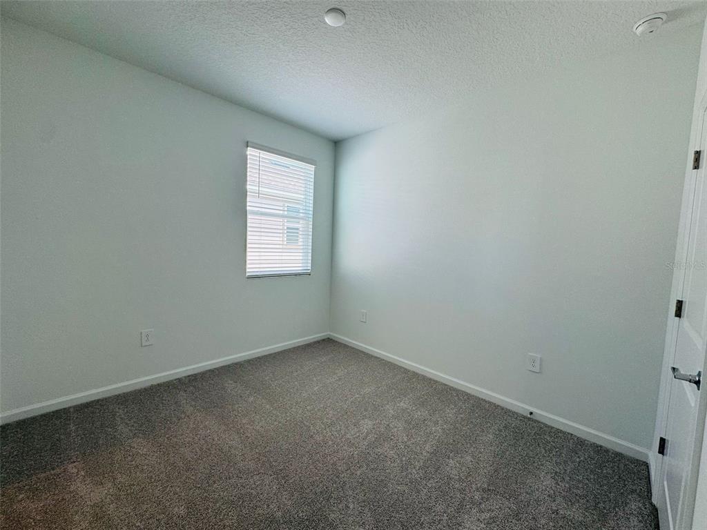 2473 Spring Tune Alley Kissimmee, FL 34744 - Photo 22 of 27 an empty room with a window