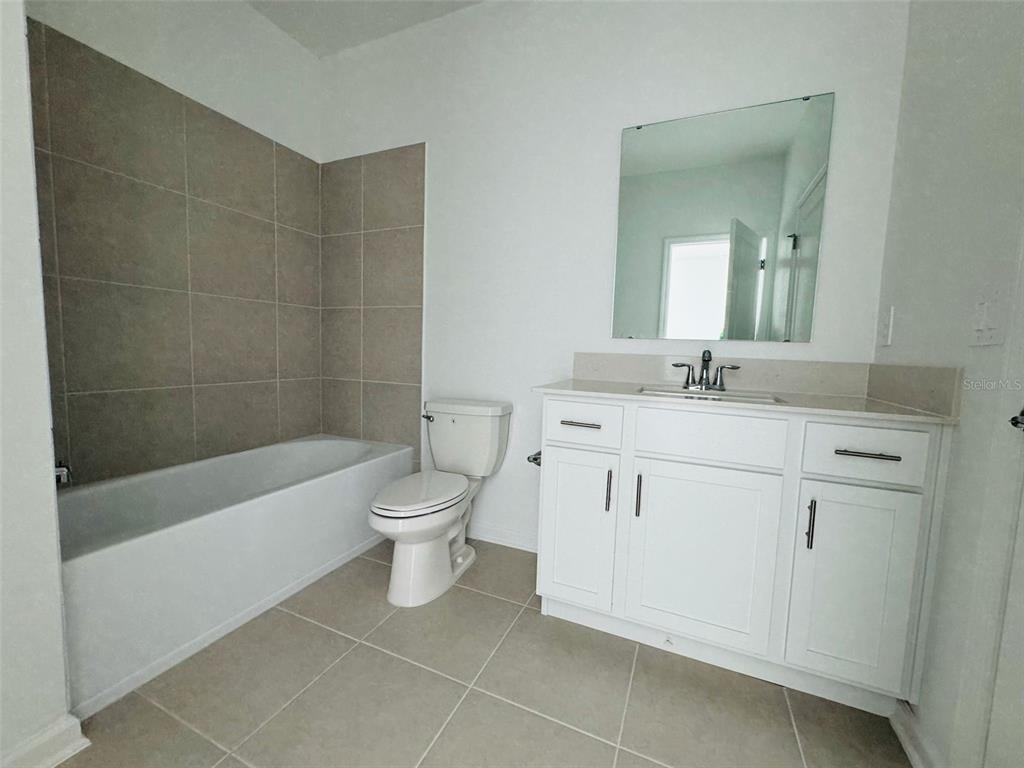 2473 Spring Tune Alley Kissimmee, FL 34744 - Photo 23 of 27 a bathroom with a sink toilet and shower