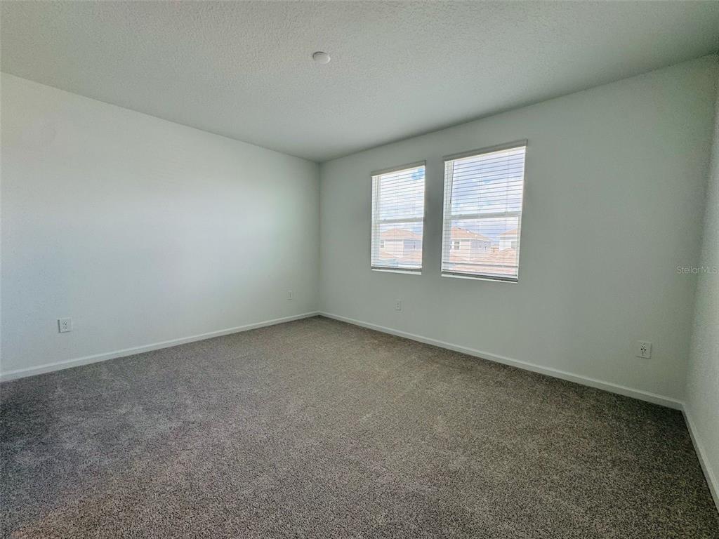 2473 Spring Tune Alley Kissimmee, FL 34744 - Photo 24 of 27 an empty room with windows