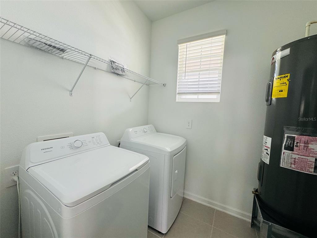2473 Spring Tune Alley Kissimmee, FL 34744 - Photo 25 of 27 a utility room with dryer and washer