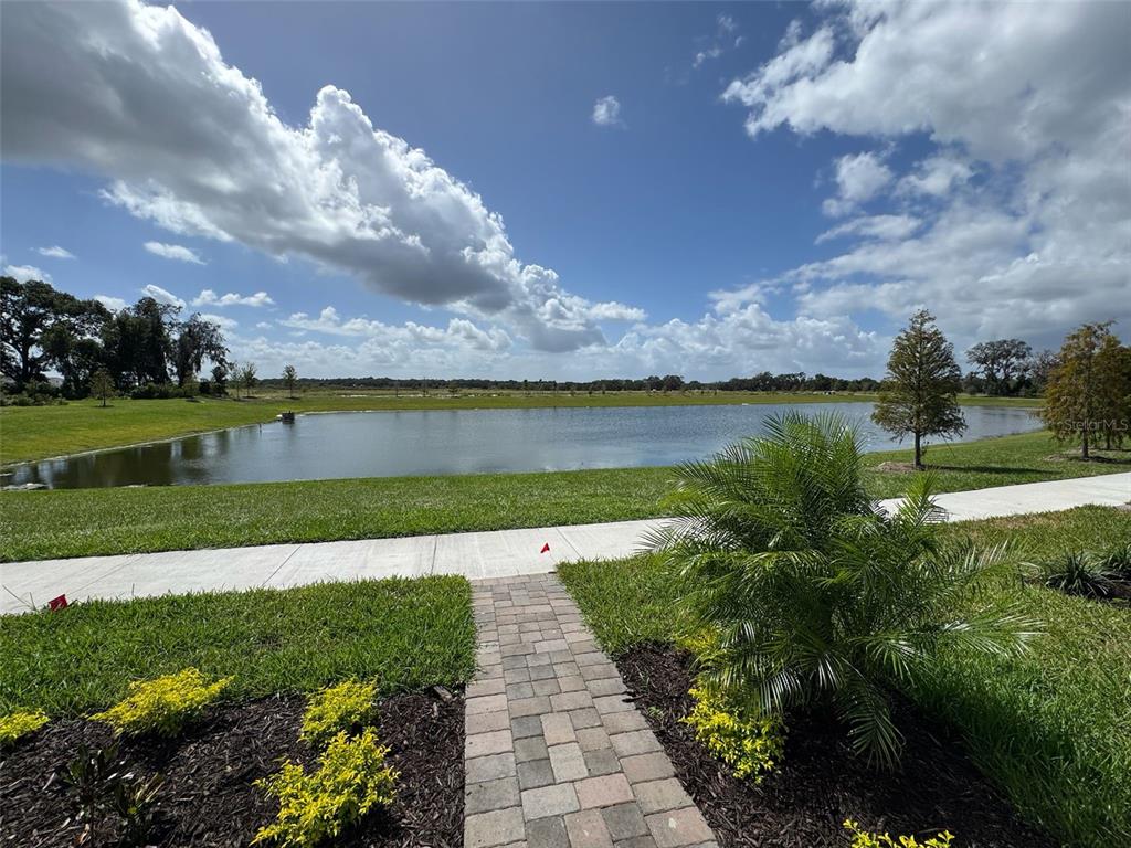 2473 Spring Tune Alley Kissimmee, FL 34744 - Photo 5 of 27 a view of a lake with a big yard
