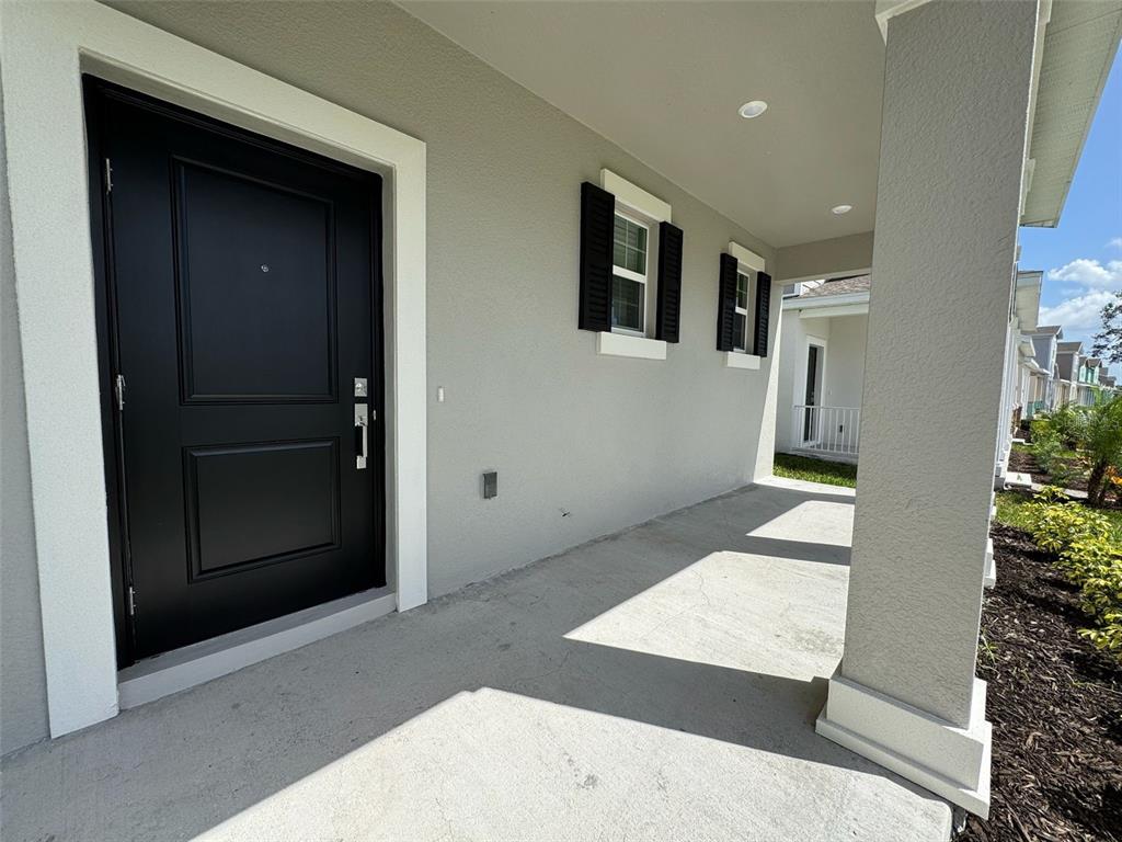 2473 Spring Tune Alley Kissimmee, FL 34744 - Photo 7 of 27 a view of a hallway with wooden floor and entryway