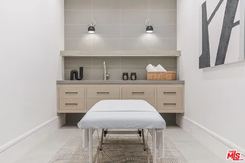 a room with a table chairs and cabinets