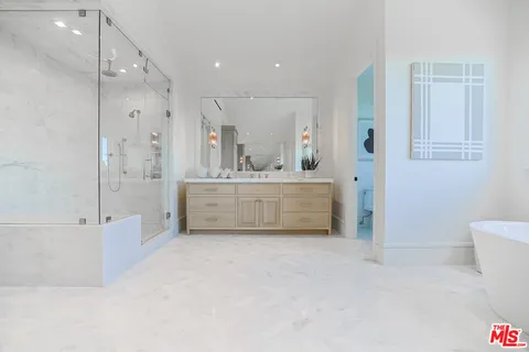 a bathroom with a bathtub sink and mirror