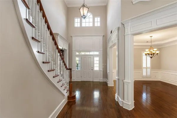 a view of an entryway with wooden floor and a front door