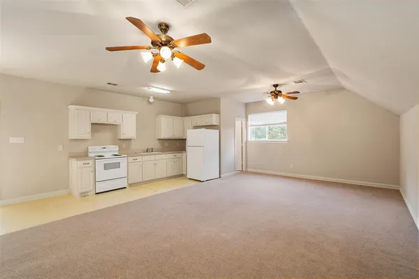 a view of an empty room with a kitchen