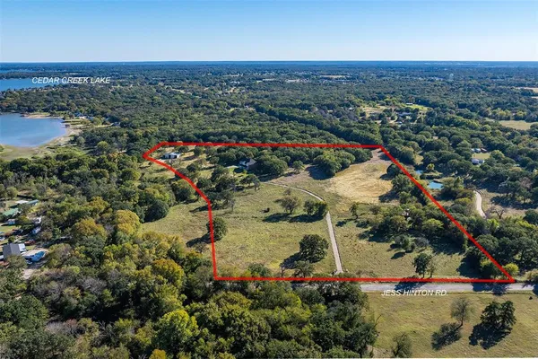 an aerial view of a houses with a lake