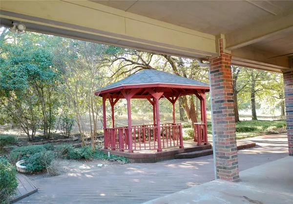 a view of a porch with a floor to ceiling window and yard