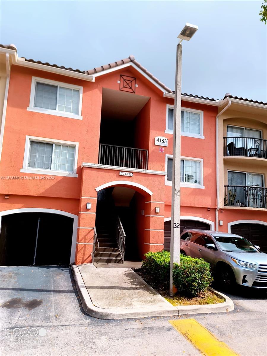 4183 Haverhill Road, Unit 712 West Palm Beach, FL 33417 - Photo 1 of 11 a front view of a house with a yard