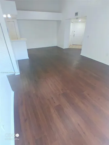 an empty room with wooden floor